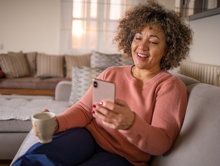 Woman smiling during a video consultation at home